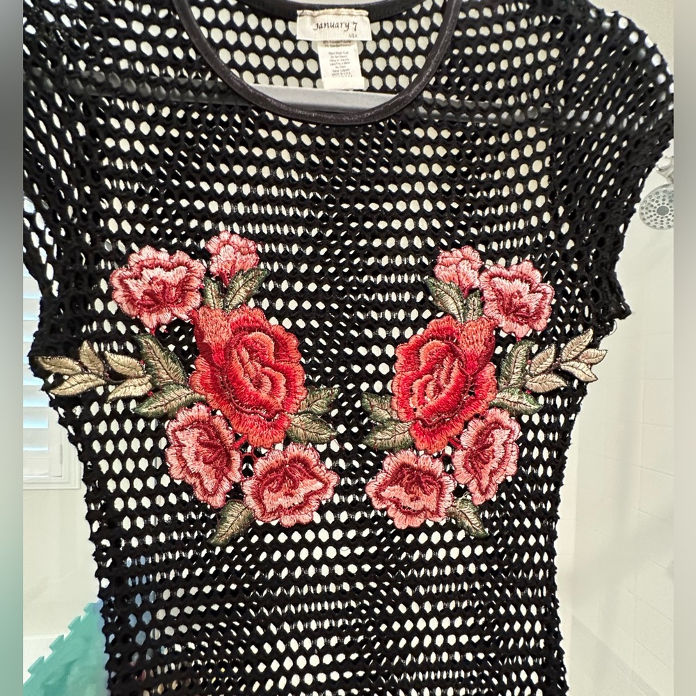 Black netted dress with rose patchwork.